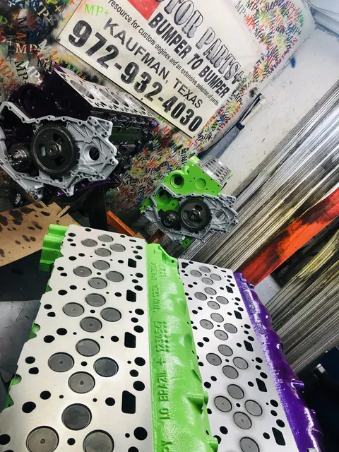 Cylinder heads in green and purple finishes