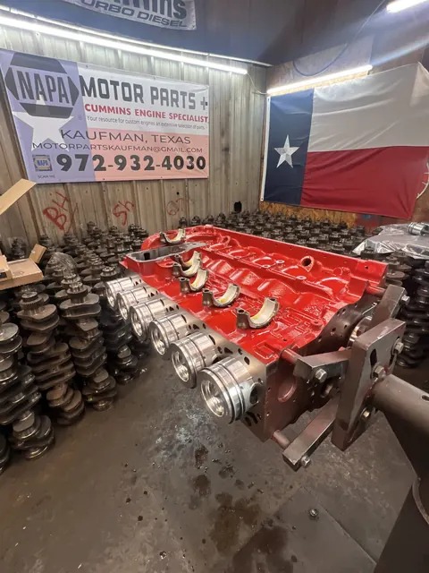 Red engine beside the Texas flag