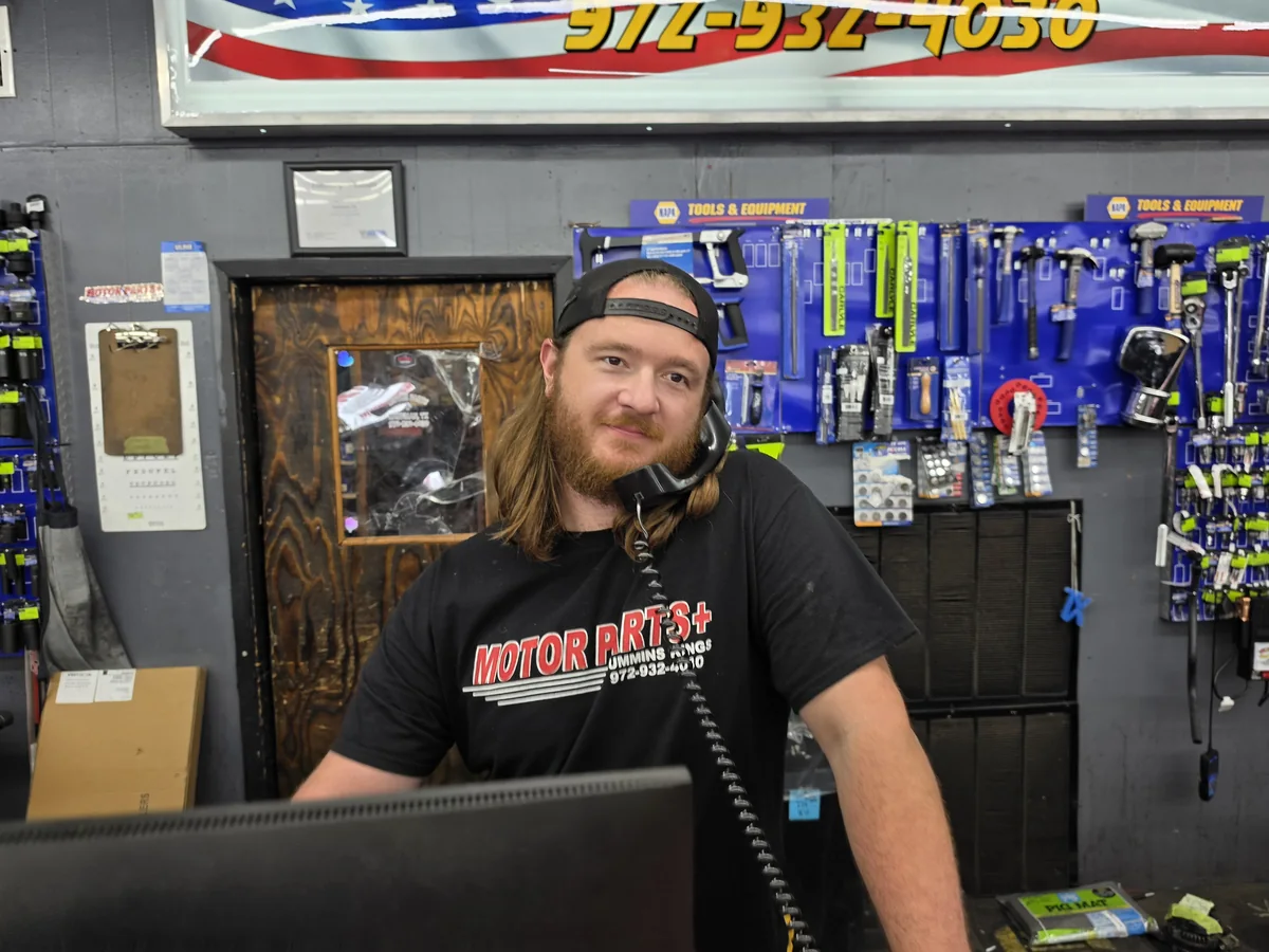 Jake, a Motor Parts + owner and Cummins engine expert, answering the phone at the shop