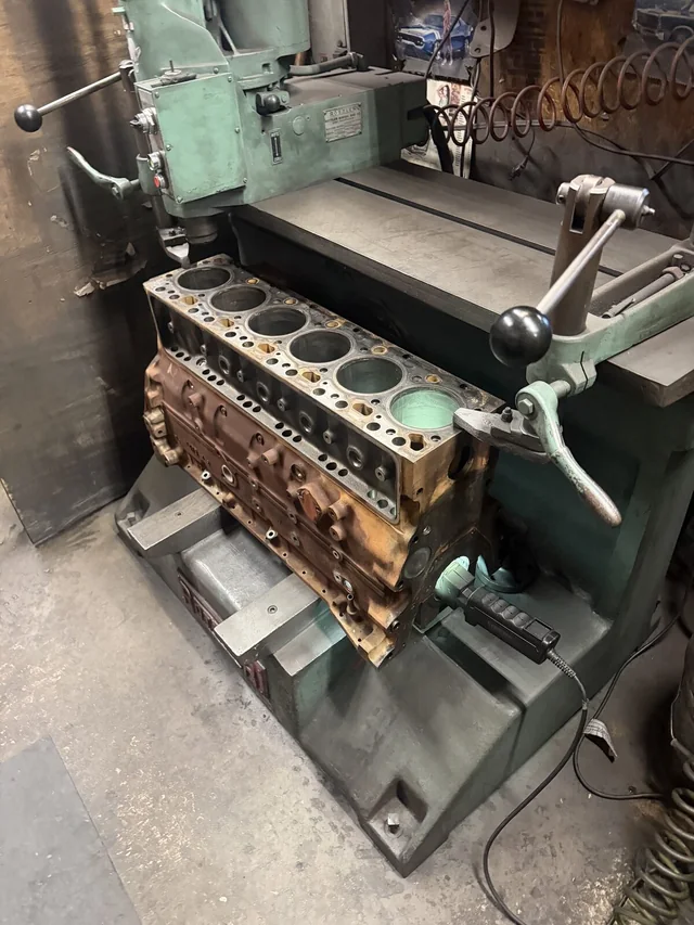 Engine block set up on a machine in the Motor Parts + machine shop